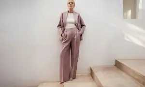 Elegancki różowy garnitur w prążki to idealna propozycja, jak się ubrać na poprawiny. Luźne spodnie i marynarka tworzą stylowy look.