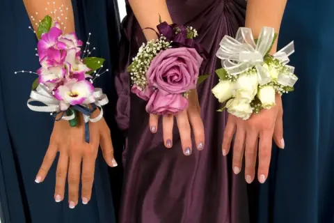 Trzy eleganckie korsarze dla świadkowej: różowe orchidee, fioletowa róża i bukiecik białych róż, ozdobione wstążkami i zielenią.